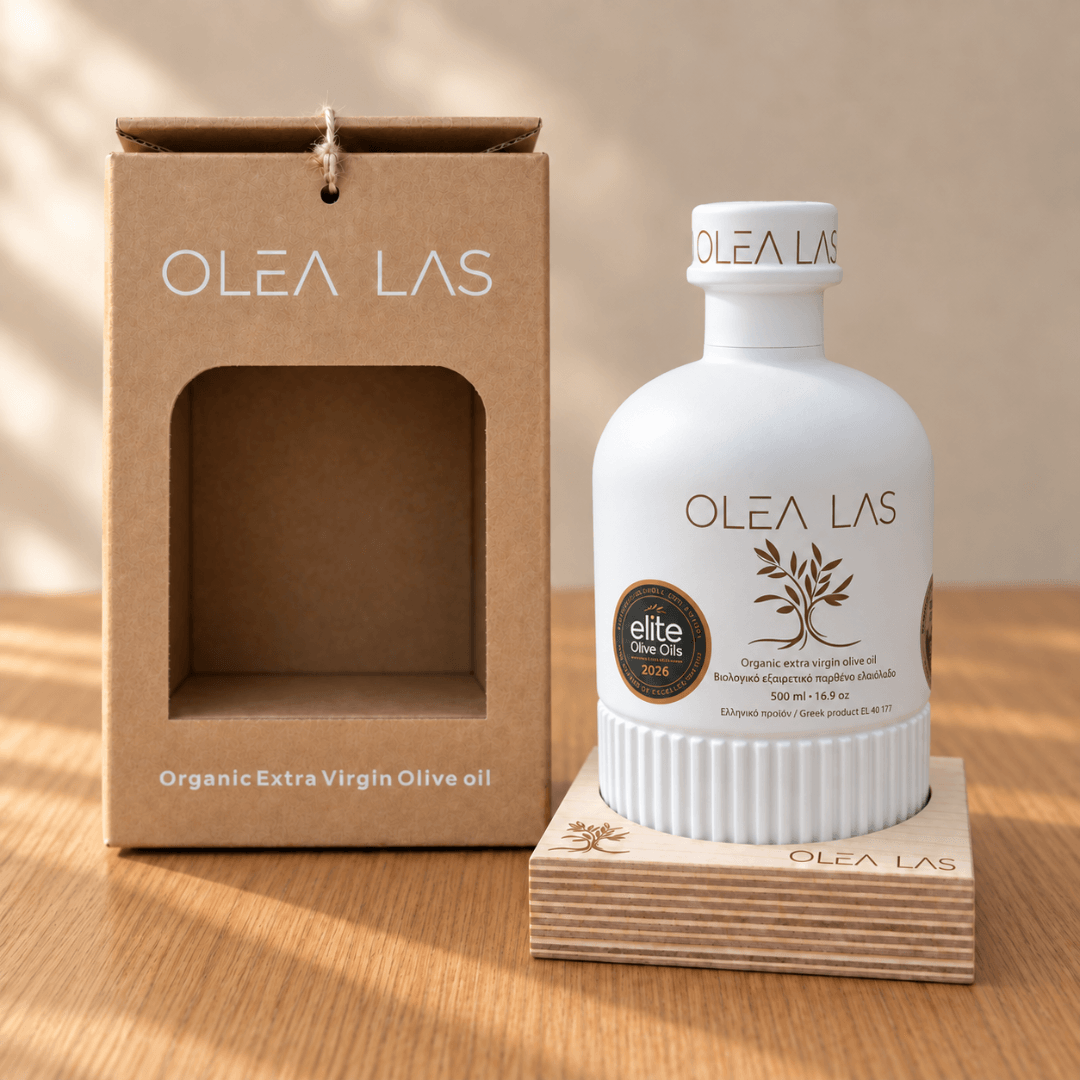 The 500 ml Olea Las bottle on its wooden stand next to the kraft gift box, on an oak table