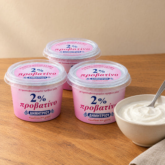Three pink cups of Dimitriou 2% sheep yogurt next to a bowl of yogurt