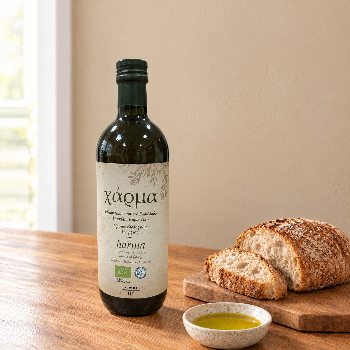 Harma Bio organic extra virgin olive oil 1L bottle, Koroneiki variety, beside bread and a dish of olive oil