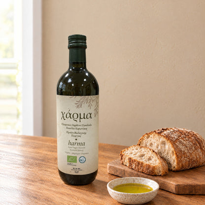Harma Bio organic extra virgin olive oil 1L bottle, Koroneiki variety, beside bread and a dish of olive oil