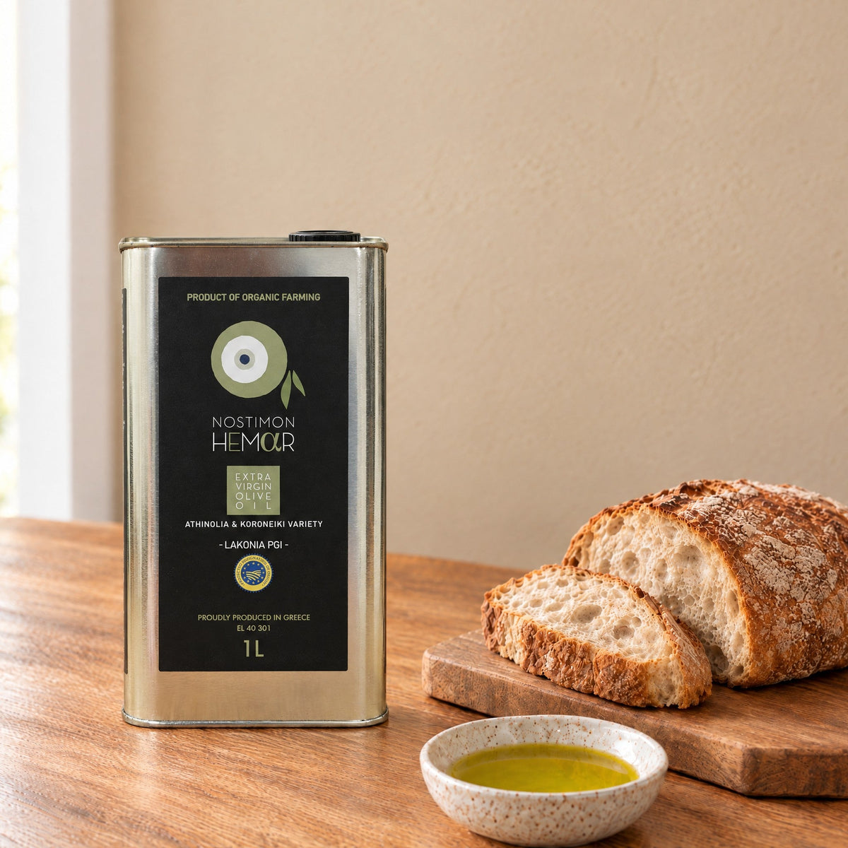 Nostimon Hemar organic PGI Lakonia extra virgin olive oil 1L tin with bread and a dish of olive oil