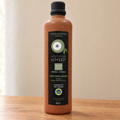 Front label of the Nostimon Hemar ceramic bottle: single-variety Athinolia, organic, PGI Lakonia