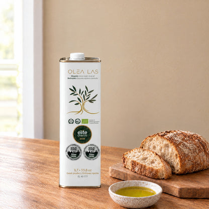 Olea Las organic extra virgin olive oil 1L tin on a kitchen table with bread and a dish of olive oil