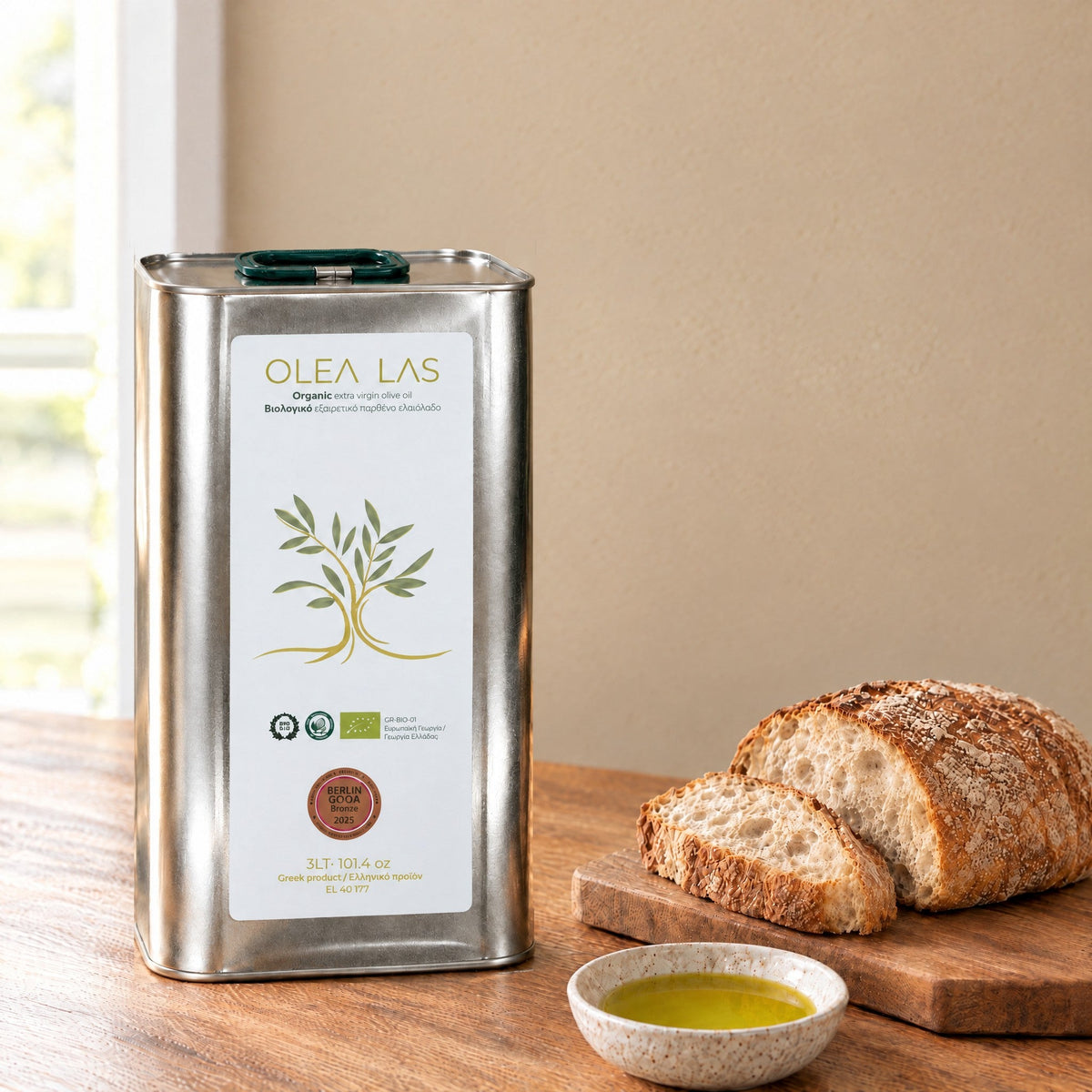 Huile d'olive vierge extra bio Olea Las en bidon de 3L sur une table de cuisine avec du pain et une coupelle d'huile