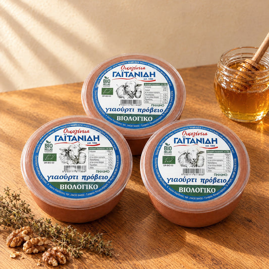 Three clay pots of Gaitanidis organic sheep yogurt seen from above, with the Greek label and EU organic logo on the lid