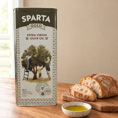 Sparta Gold extra virgin olive oil 5L tin on a kitchen table with bread and a dish of olive oil