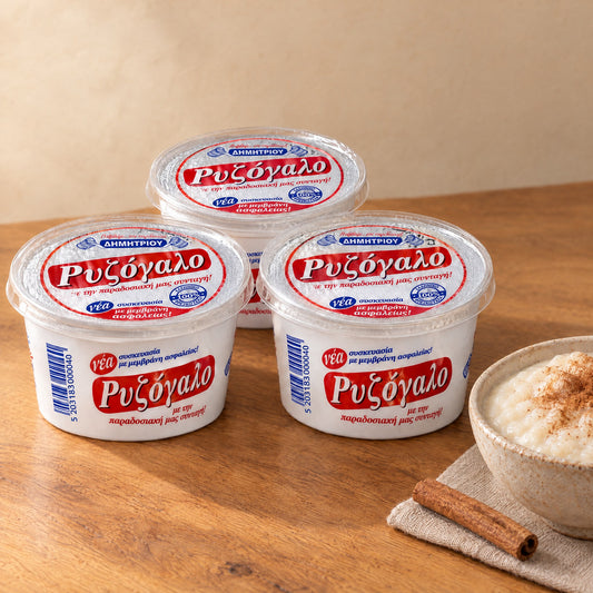 Three cups of Dimitriou rizogalo next to a bowl of rice pudding dusted with cinnamon